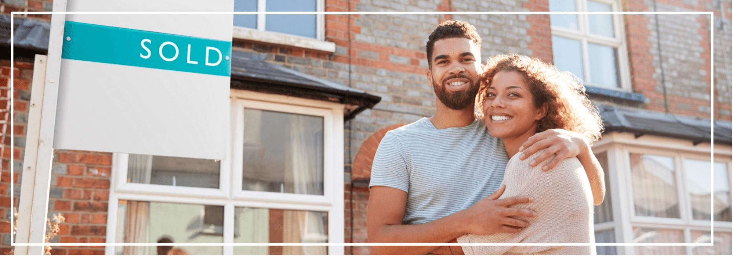 Man and a woman stood in front of their house as first time buyers.
